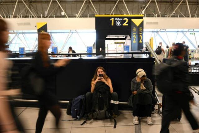 <p>Waiting game: travellers at Gatwick airport the day after the Nats failure </p>