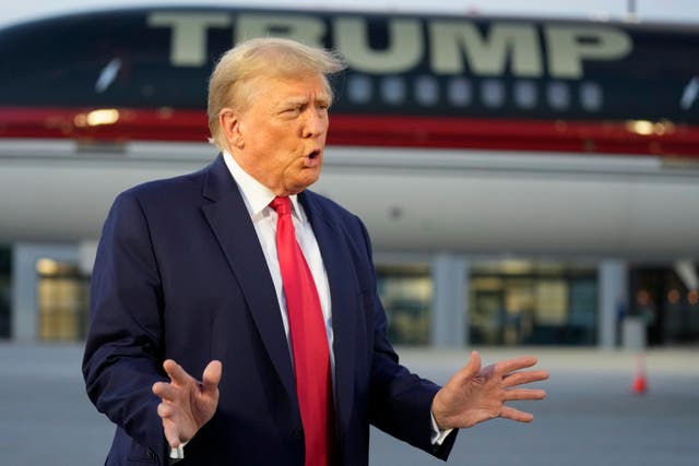 <p>Donald Trump speaks to reporters in front of his plane in Georgia </p>