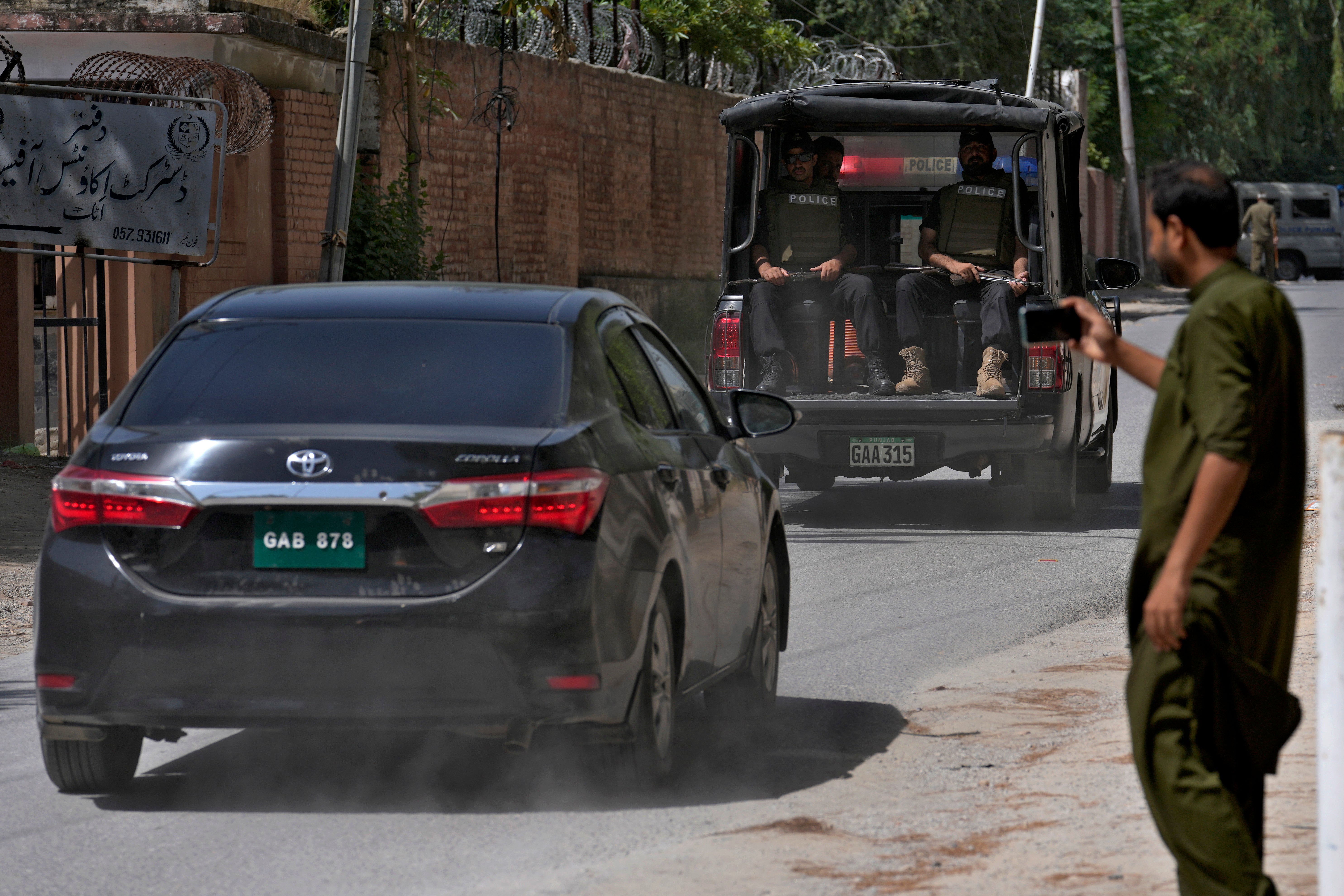 A police squad escort a car carrying a judge of special court leaving after a case hearing of Pakistan’s former prime minister Imran Khan on 30 August