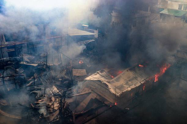 Smoke bellows from houses in flames after a suspected arson attack by unknown miscreants, following ongoing ethnic violence in Imphal on 27 August 2023