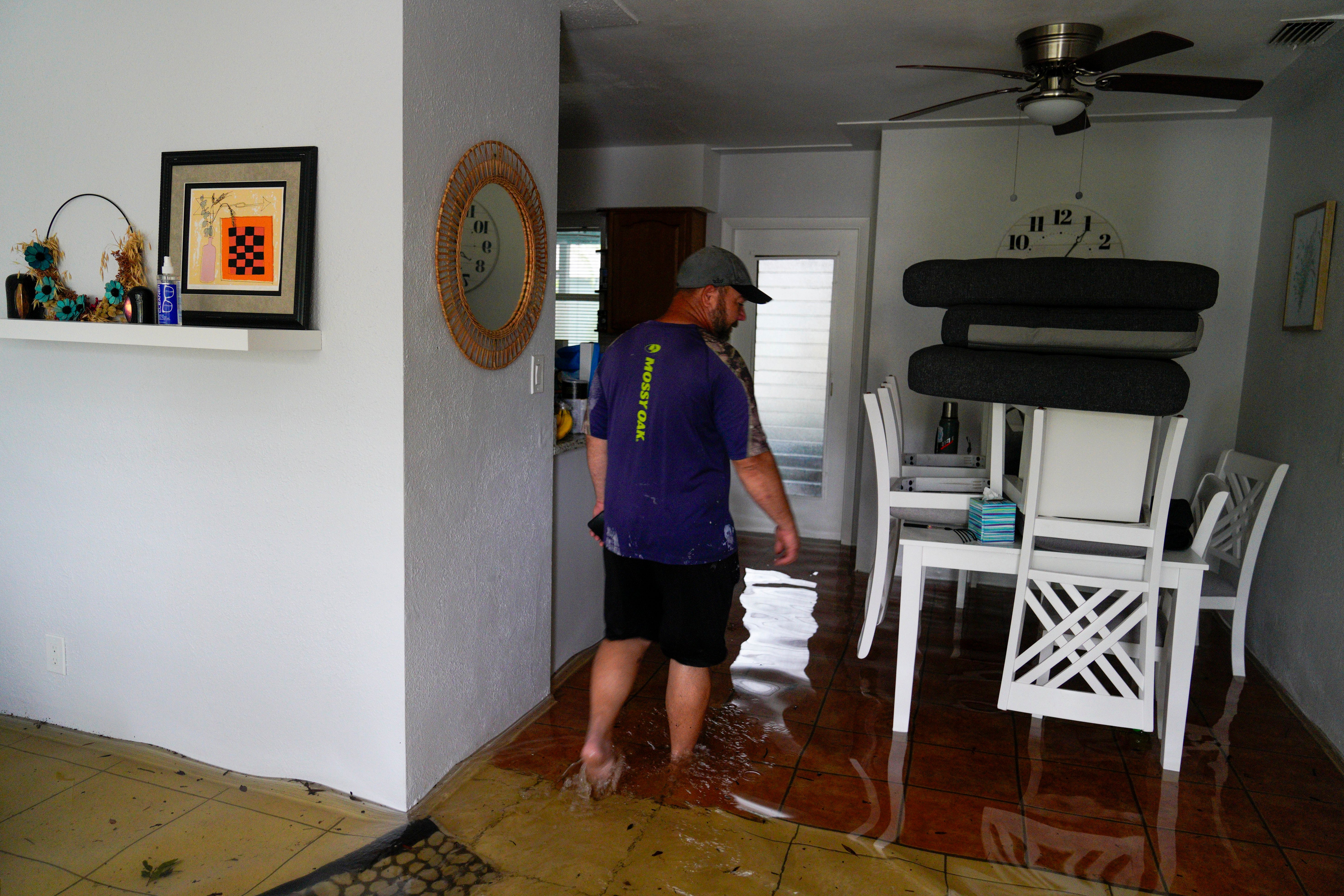 Chad Hinchman, 40, walks through one of his rental Airbnb properties on Hibiscus Avenue South, Pasadena, which flooded overnight