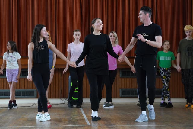Kristina Bondarenko (centre), from Ukraine, who learned Irish dancing in her native Odesa before fleeing the war takes part in a class with members of the Riverdance troupe Jason O’Neill (right), from Belfast, and Emma Mannion (second left), from Roscommon, at the Rathmines Ukrainian Community Centre in Dublin (Brian Lawless/PA)