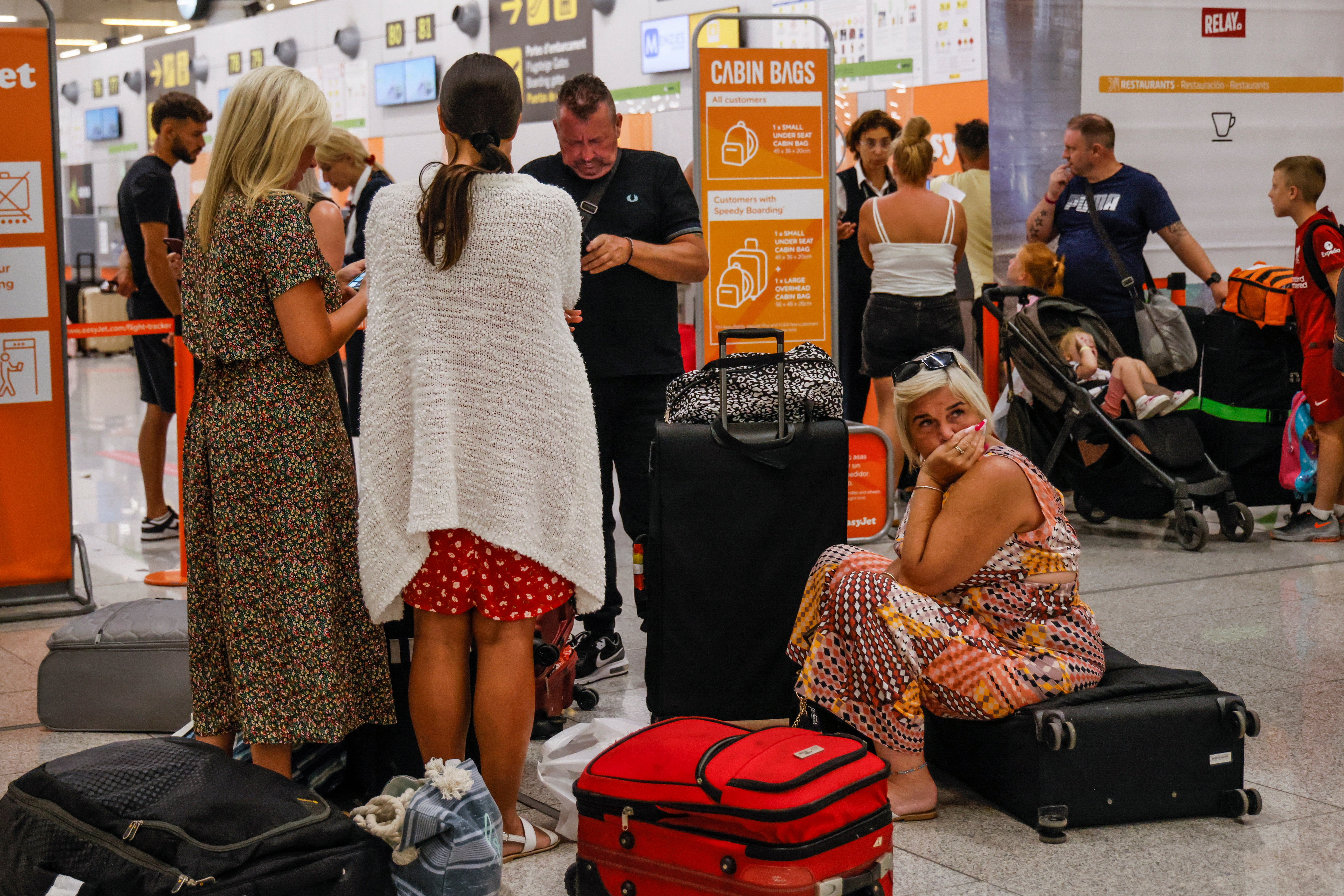 Tourists wait at the airport of Palma for their return flight to Italy d