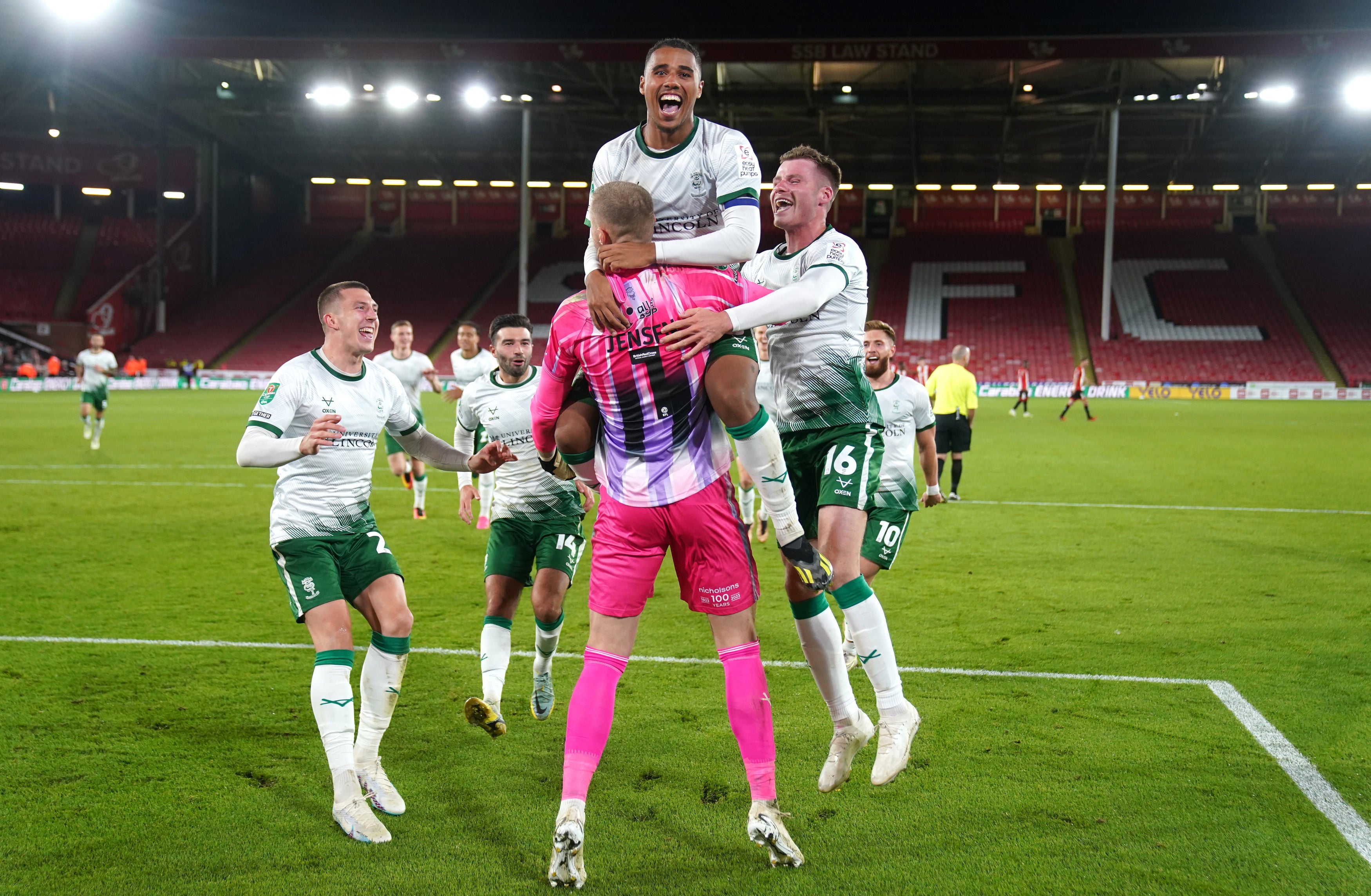 Lincoln players celebrate their victory over Sheffield United