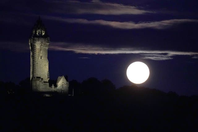 The super blue moon rises over The Wallace Monument in Stirling (Andrew Milligan/PA)