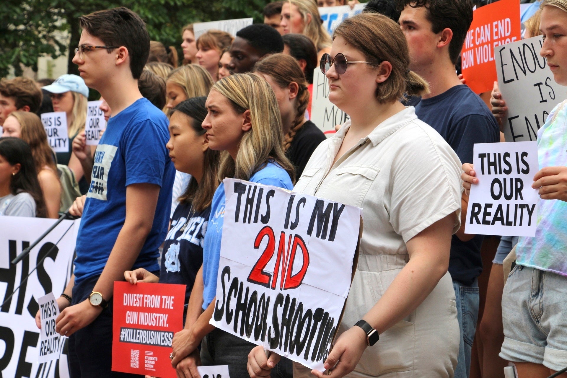 Students hold signs during a gun safety rally following a fatal shooting