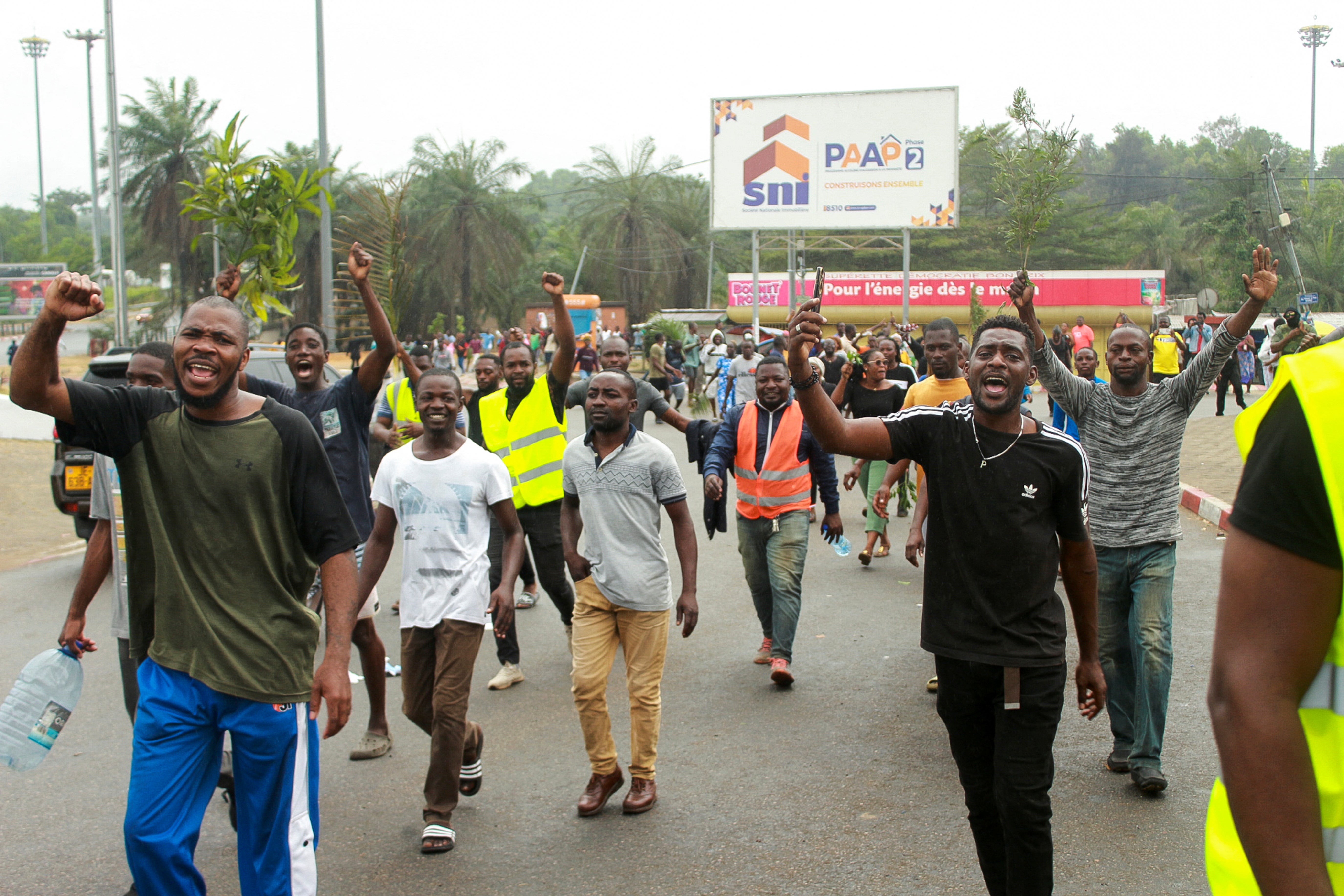 People celebrate in support of the putschists in a street of Libreville on 30 August