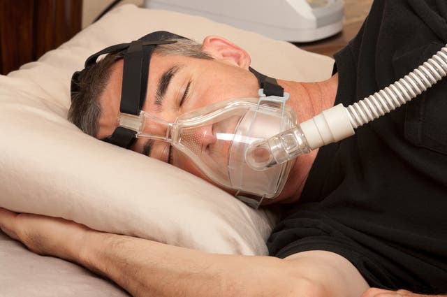 <p>Man with sleeping apnea and CPAP machine</p>