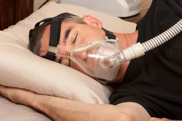 <p>Man with sleeping apnea and CPAP machine</p>