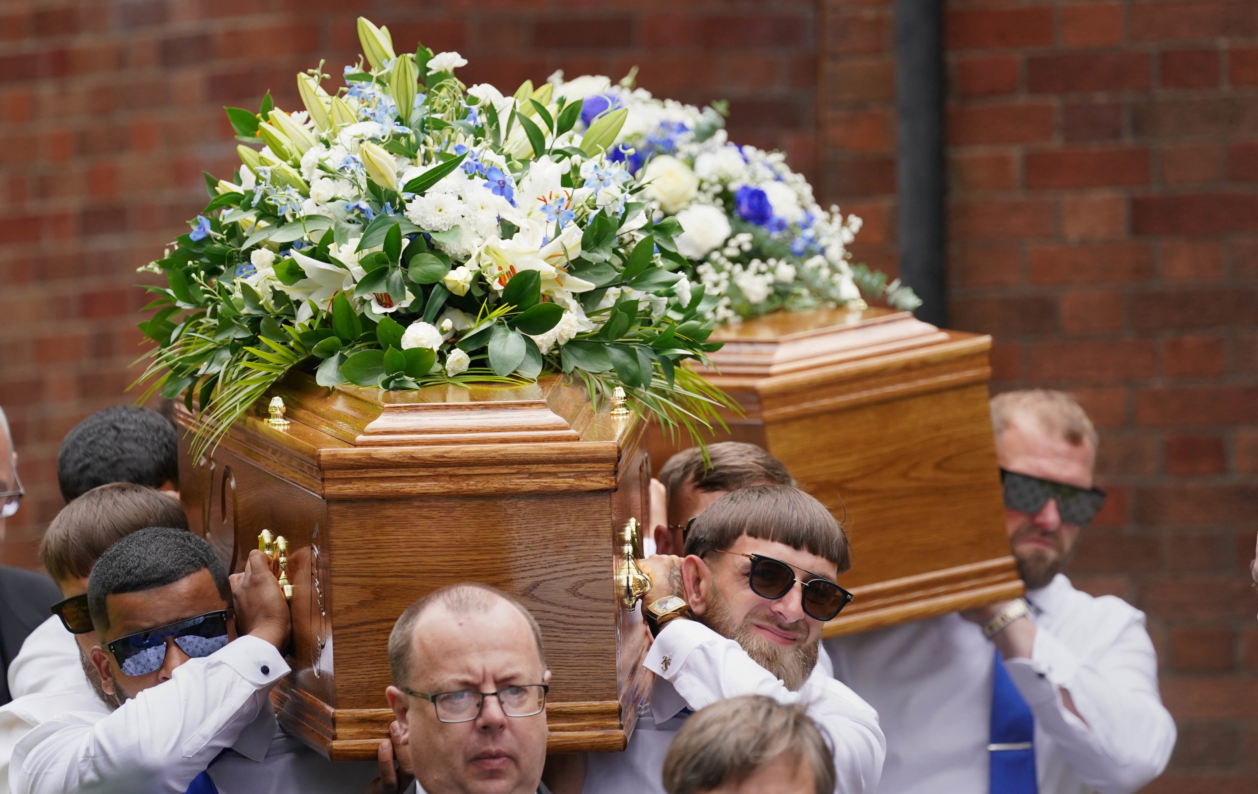 Floral tributes on their coffins read “best friends” and “forever young”