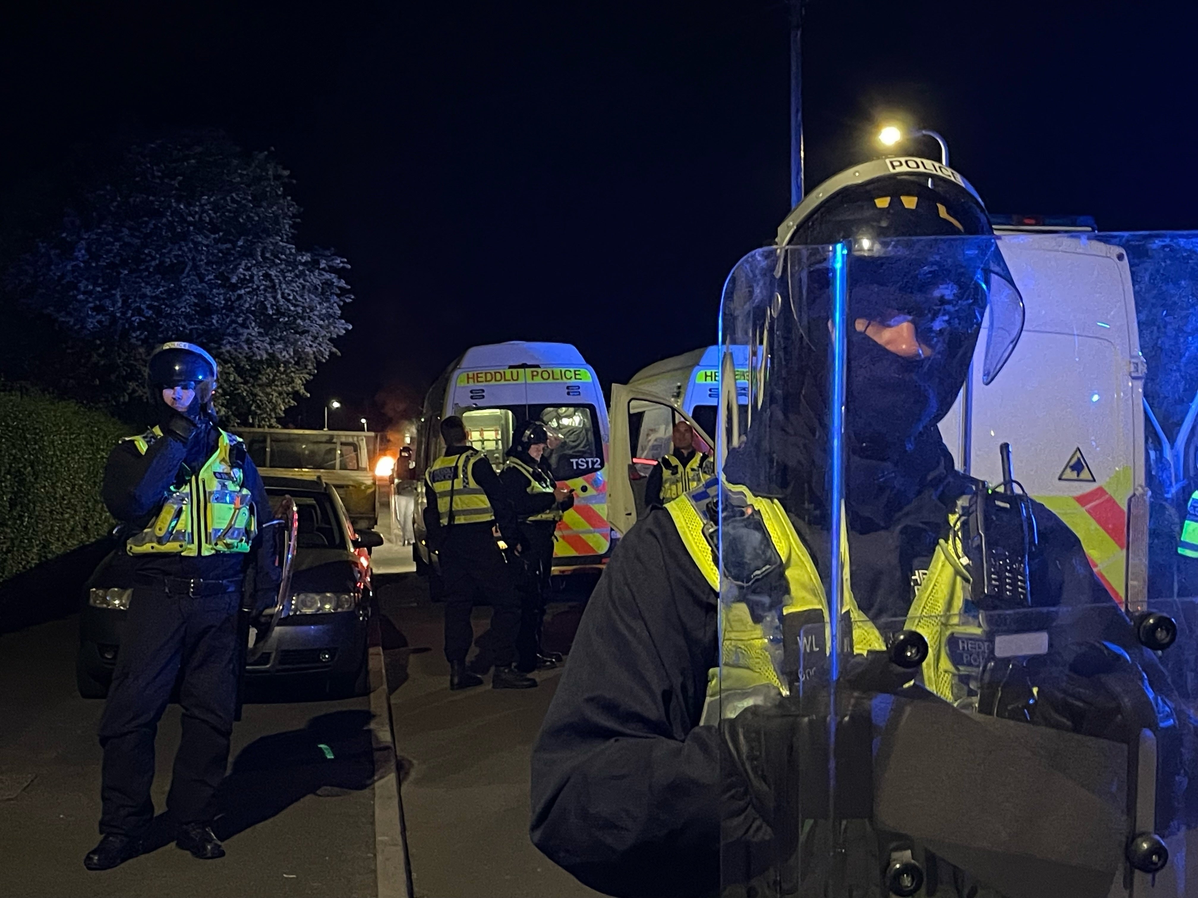 Following their deaths, scenes being livestreamed on YouTube showed people throwing fireworks and other missiles at a line of police officers with riot shields who were blocking one end of the street