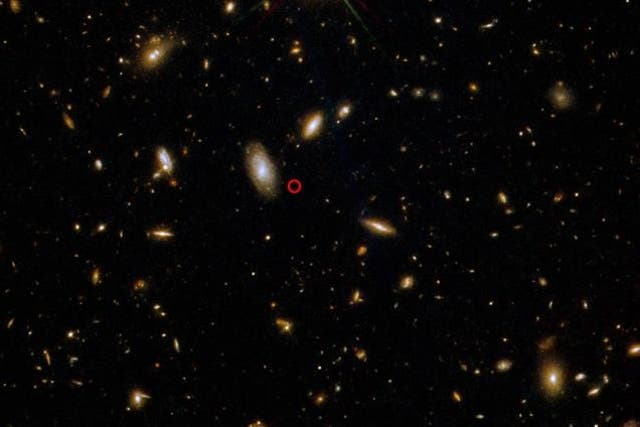 <p>GRB 211211A’s location, circled in red, captured using three filters on Hubble’s Wide Field Camera 3.</p>