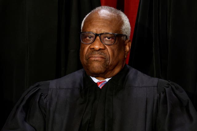 <p>Clarence Thomas appears in a class photo of the Supreme Court </p>