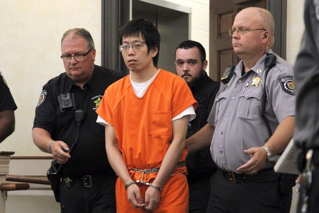 <p>Tailei Qi, the graduate student suspected in the fatal shooting of a University of North Carolina at Chapel Hill faculty member, center, makes his first appearance at the Orange County Courthouse</p>