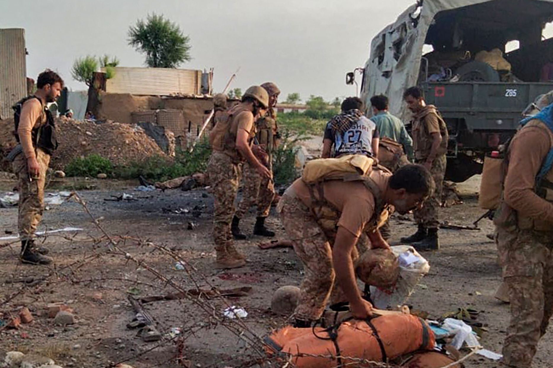 Pakistani army personnel inspect the site of a bomb attack in the Bannu district of Khyber Pakhtunkhwa province
