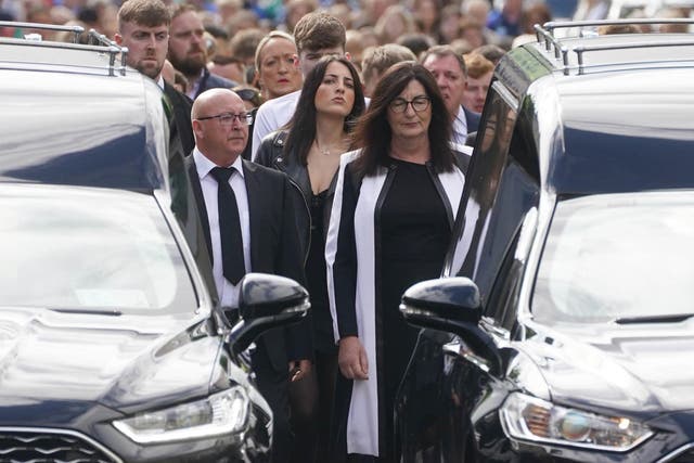 Family members and mourners follow the hearses carrying the coffins of siblings Luke and Grace McSweeney as they make their way to Saints Peter and Paul’s Church, Clonmel, Co Tipperary, ahead of their funeral service (Brian Lawless/PA)