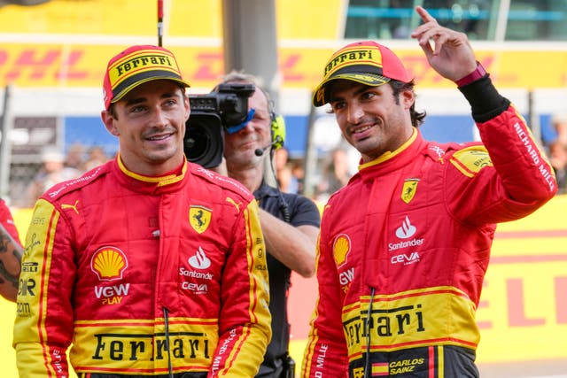 Ferrari driver Carlos Sainz of Spain, right, celebrates his pole position (Luca Bruno/AP)