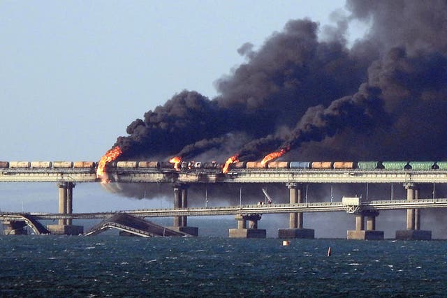 <p>Black smoke billows from a fire on the Kerch bridge that links Crimea to Russia after a truck exploded, October 2022 </p>