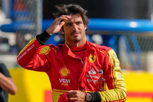 Ferrari driver Carlos Sainz of Spain celebrates his pole position after the qualifying session ahead of Sunday’s Formula One Italian Grand Prix auto race, at the Monza racetrack, in Monza, Italy, Saturday, Sept. 2, 2023. (AP Photo/Luca Bruno)