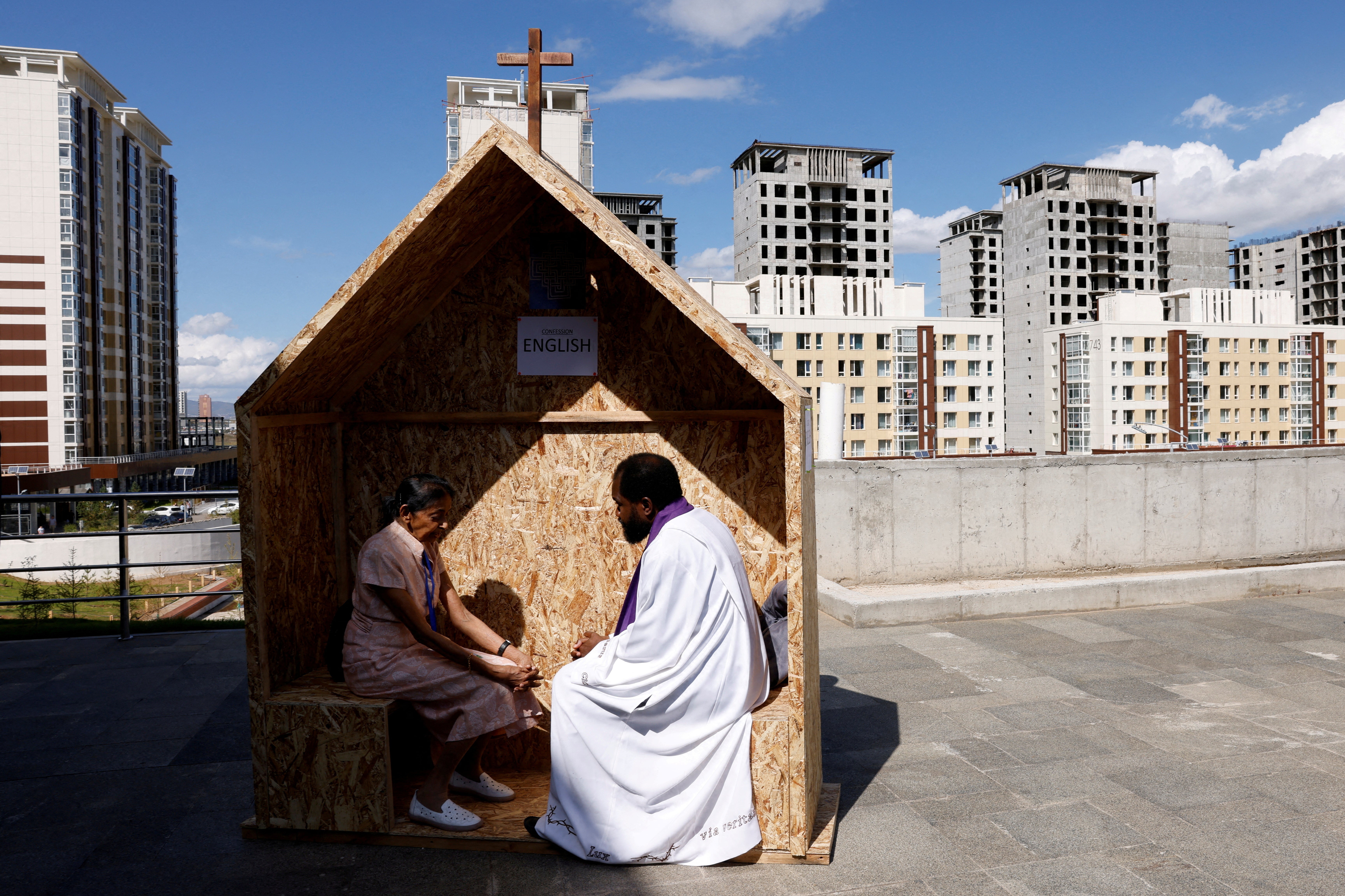 A woman confesses outside the Steppe Arena, ahead of Pope Francis' arrival to celebrate the Holy Mass, during his Apostolic Journey in Ulaanbaatar, Mongolia