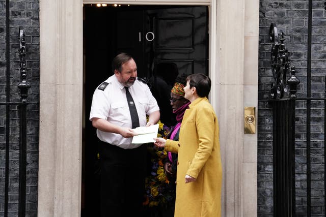 Caroline Lucas handed a copy of the Clean Air (Human Rights) Bill into 10 Downing Street in February alongside Rosamund Kissi-Debrah (PA)