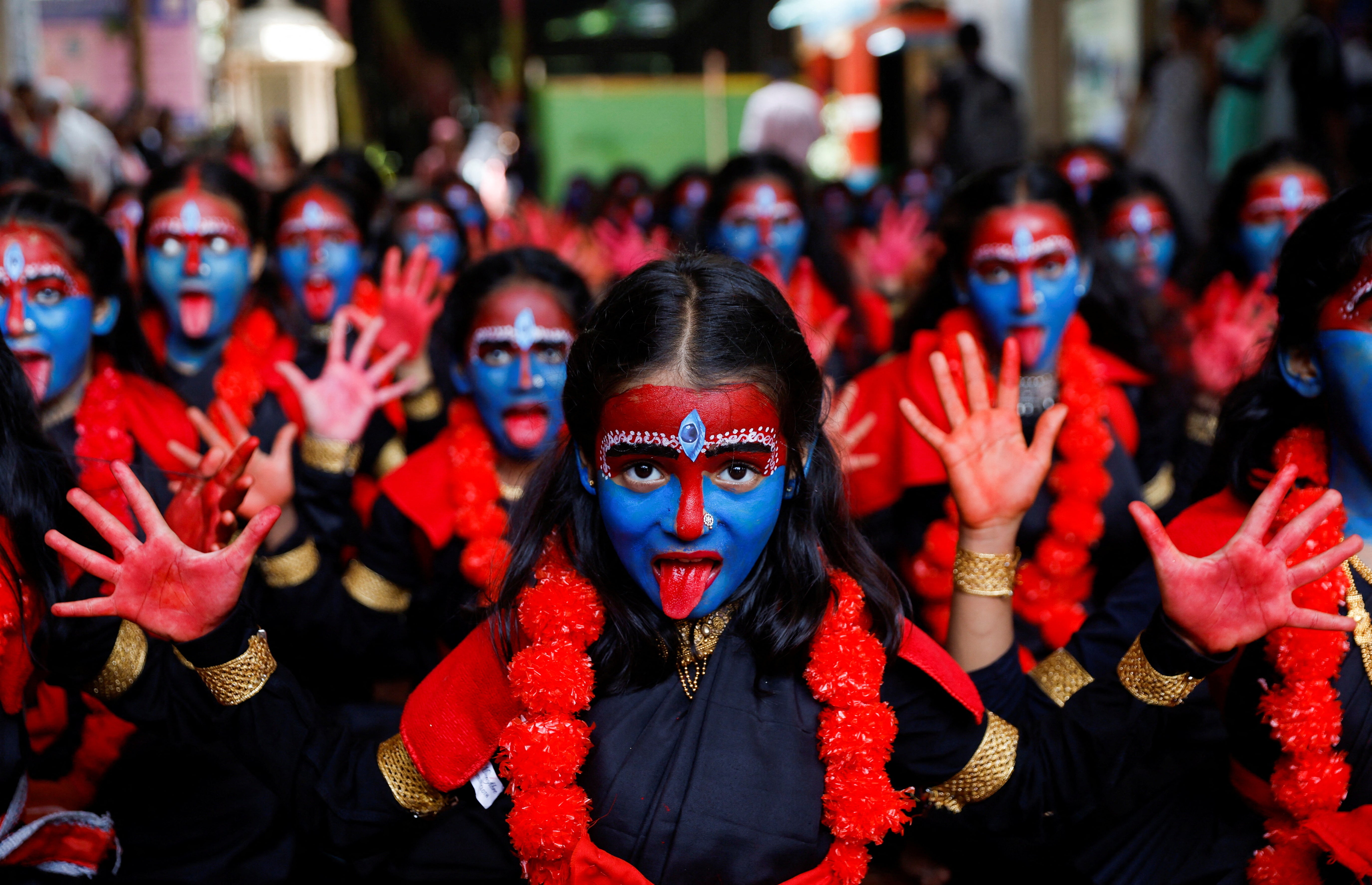 Students made up to resemble the Hindu goddess Kali take part in an event ahead of the Janmashtami festival in Mumbai, India