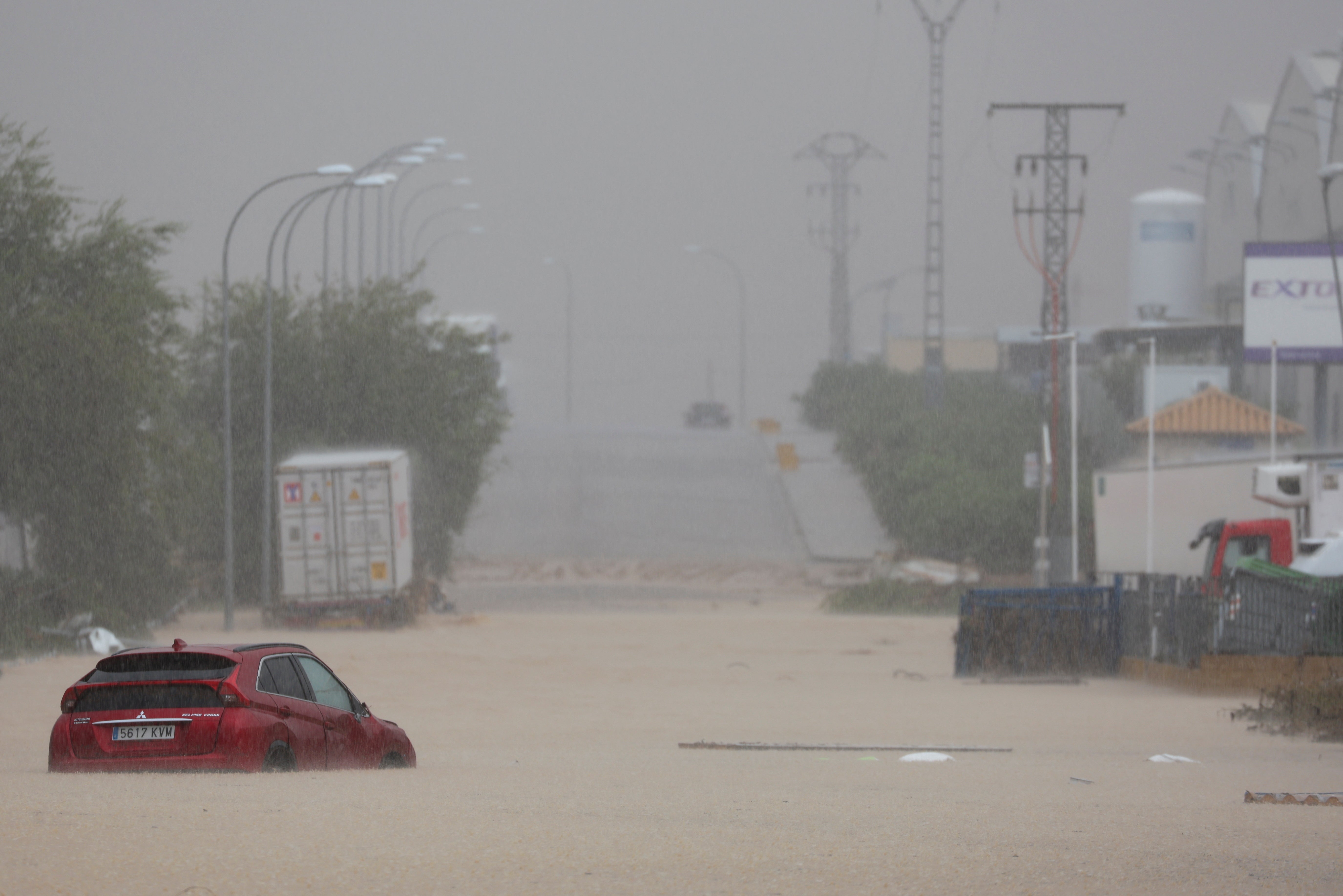 A car is stranded after heavy rain in Toledo, Spain