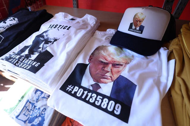 <p>T-shirts and hats with an image depicting the mugshot of former U.S. President Donald Trump are pictured after being printed at the Y-Que printing store in Los Angeles, California, U.S., August 26, 2023. REUTERS/Mario Anzuoni</p>