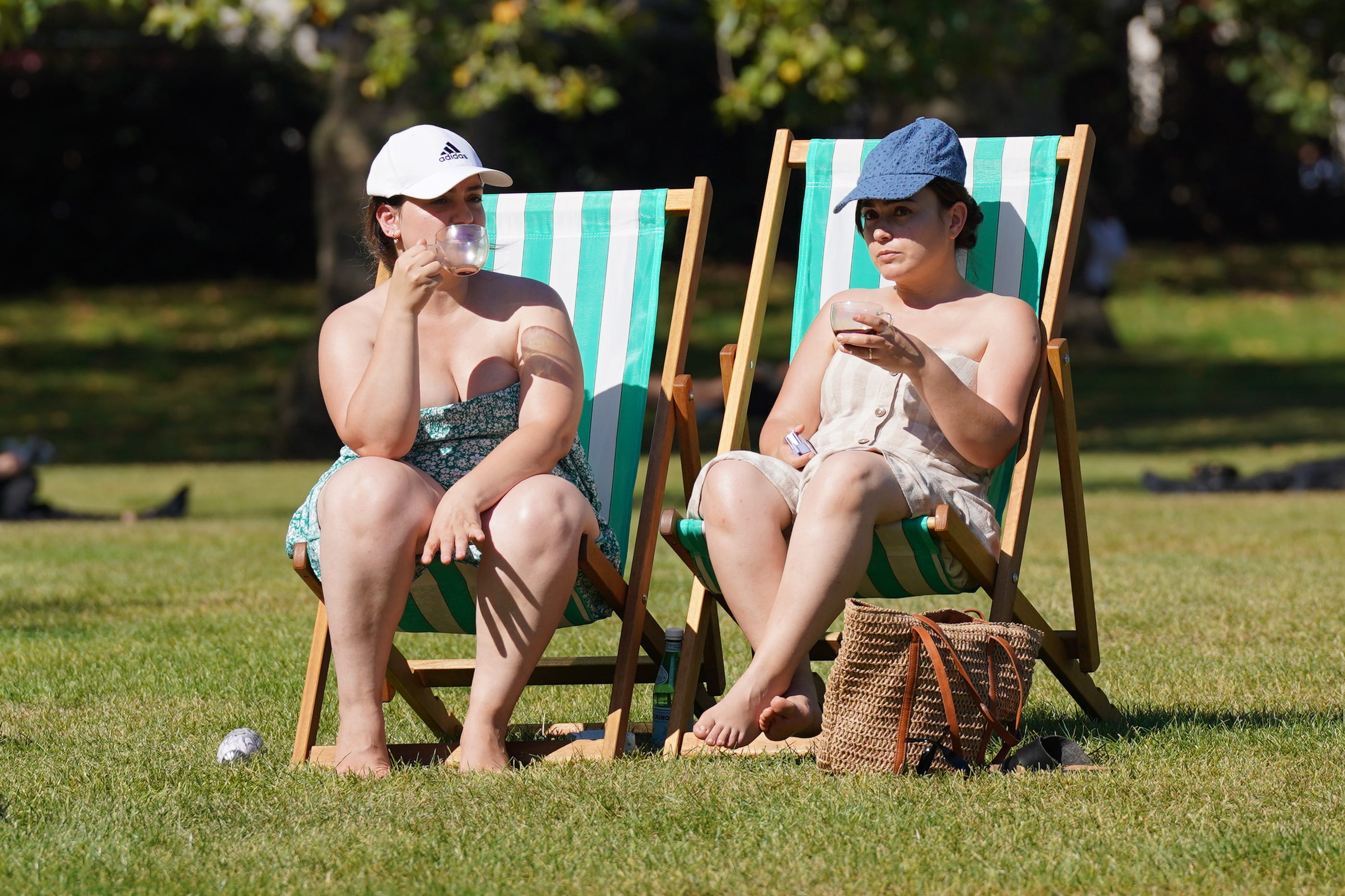 People enjoying the hot weather in Green Park, central London (Lucy North/PA)