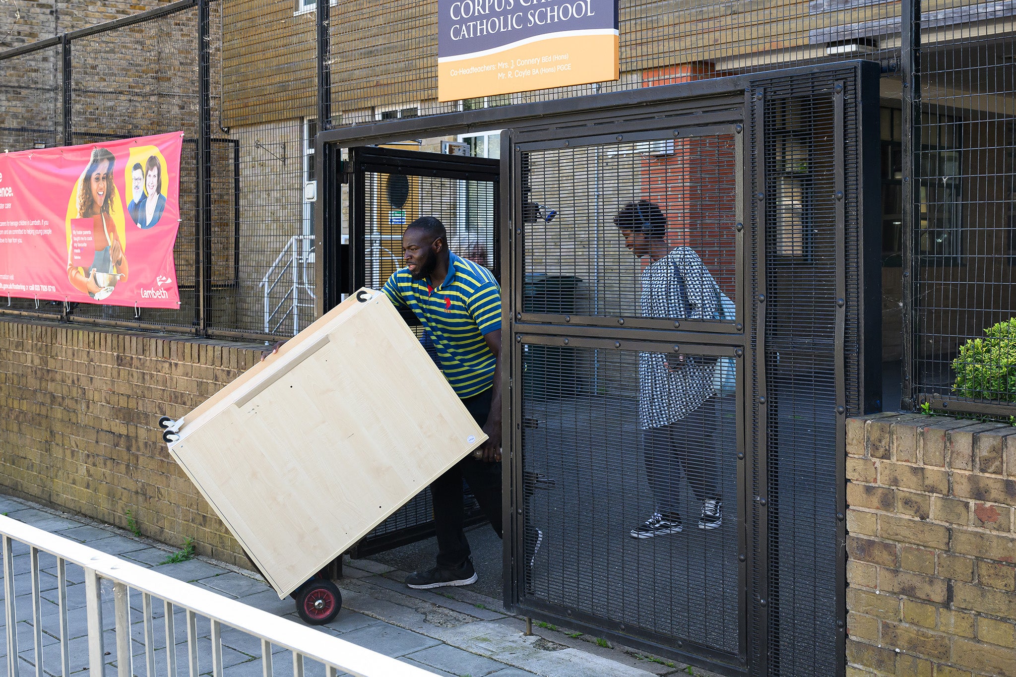 A piece of furniture is removed from a building at Corpus Christi Catholic School in London after it was warned over crumbling concrete