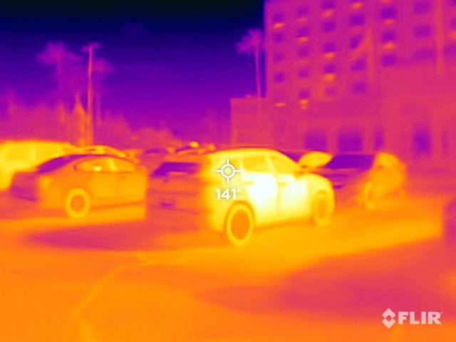 A black car registers 141F (60C) surface temperature outside a hotel in Phoenix on 26 July
