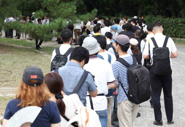 People wait in line for tickets to attend the first trial of Shinji Aoba, the defendant in the Kyoto Animation arson murder case