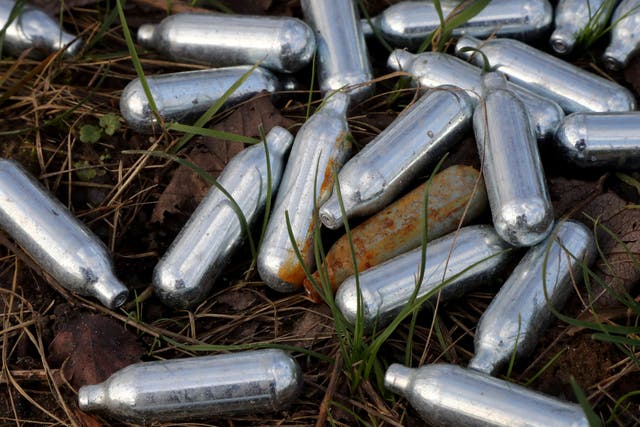 A view of canisters of nitrous oxide, or laughing gas, discarded by the side of a road (Gareth Fuller/PA)