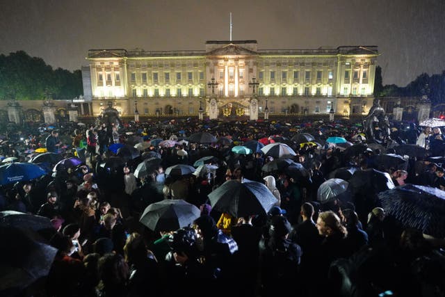 Members of the public gather outside Buckingham Palace following the death of Queen Elizabeth II (Victoria Jones/PA)