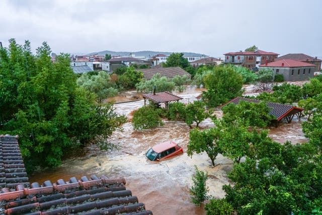 <p>A car is submerged under water during a storm on mount Pelion, near Volos, Greece</p>