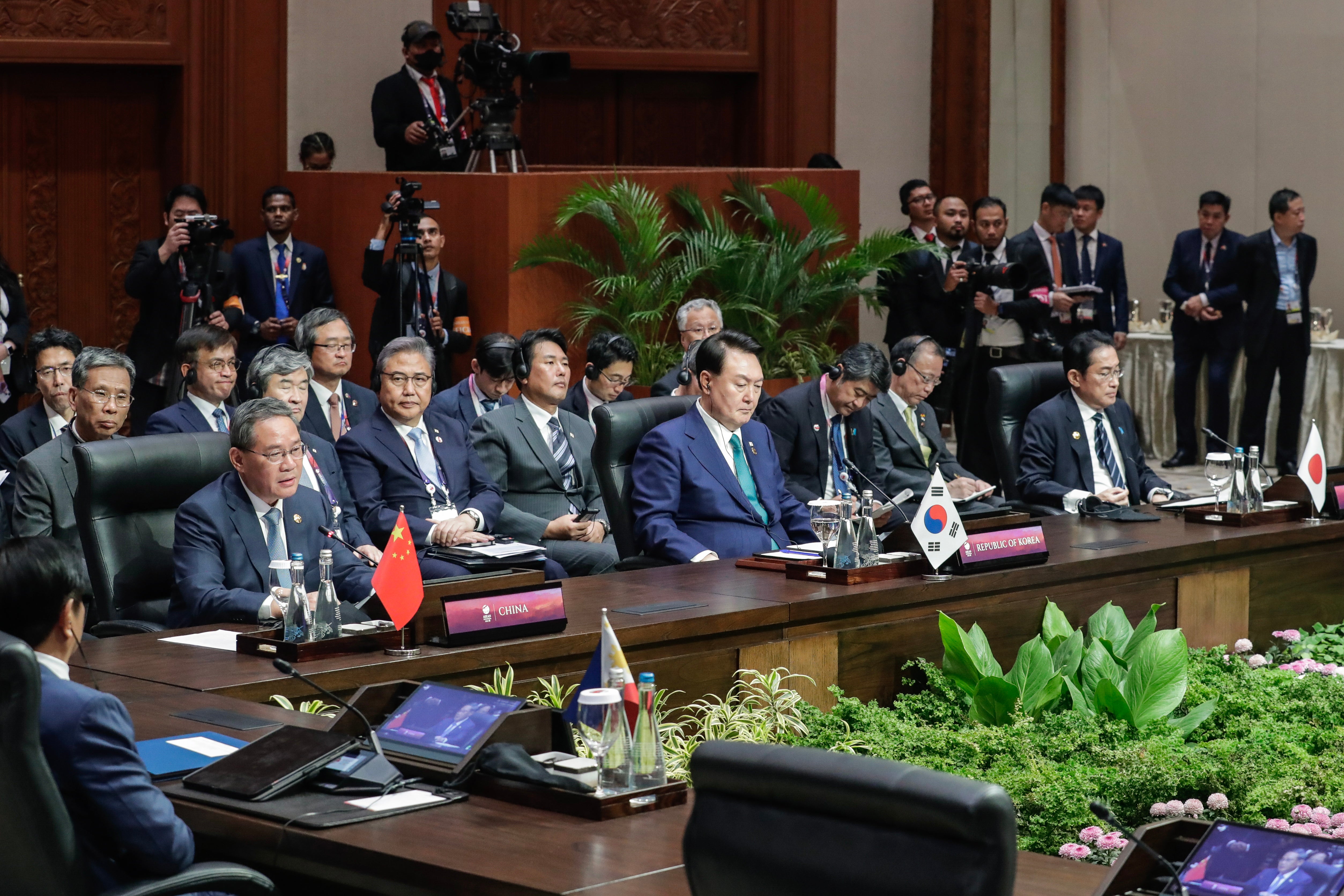 China’s Premier Li Qiang (L) delivers remarks as South Korean president Yoon Suk Yeol (C) and Japan’s prime minister Fumio Kishida (R) listen during the Asean Plus Three (APT) summit