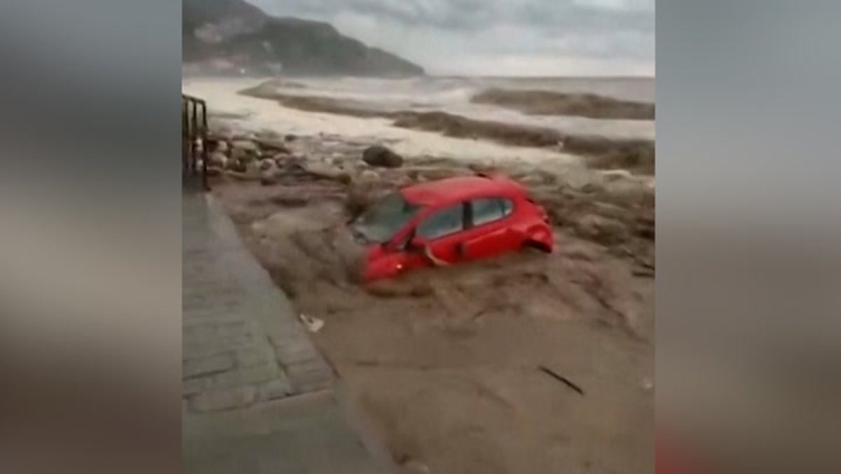 Moment Greece flooding sweeps cars into sea as roads turn into fast-flowing rivers
