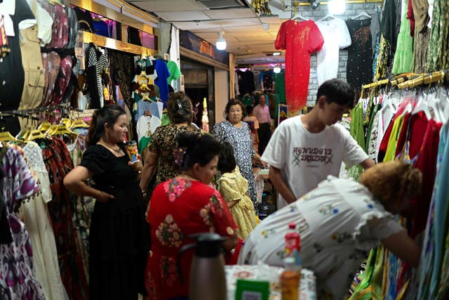 <p>People buying clothes in Kashgar city in northwestern China’s Xinjiang region</p>