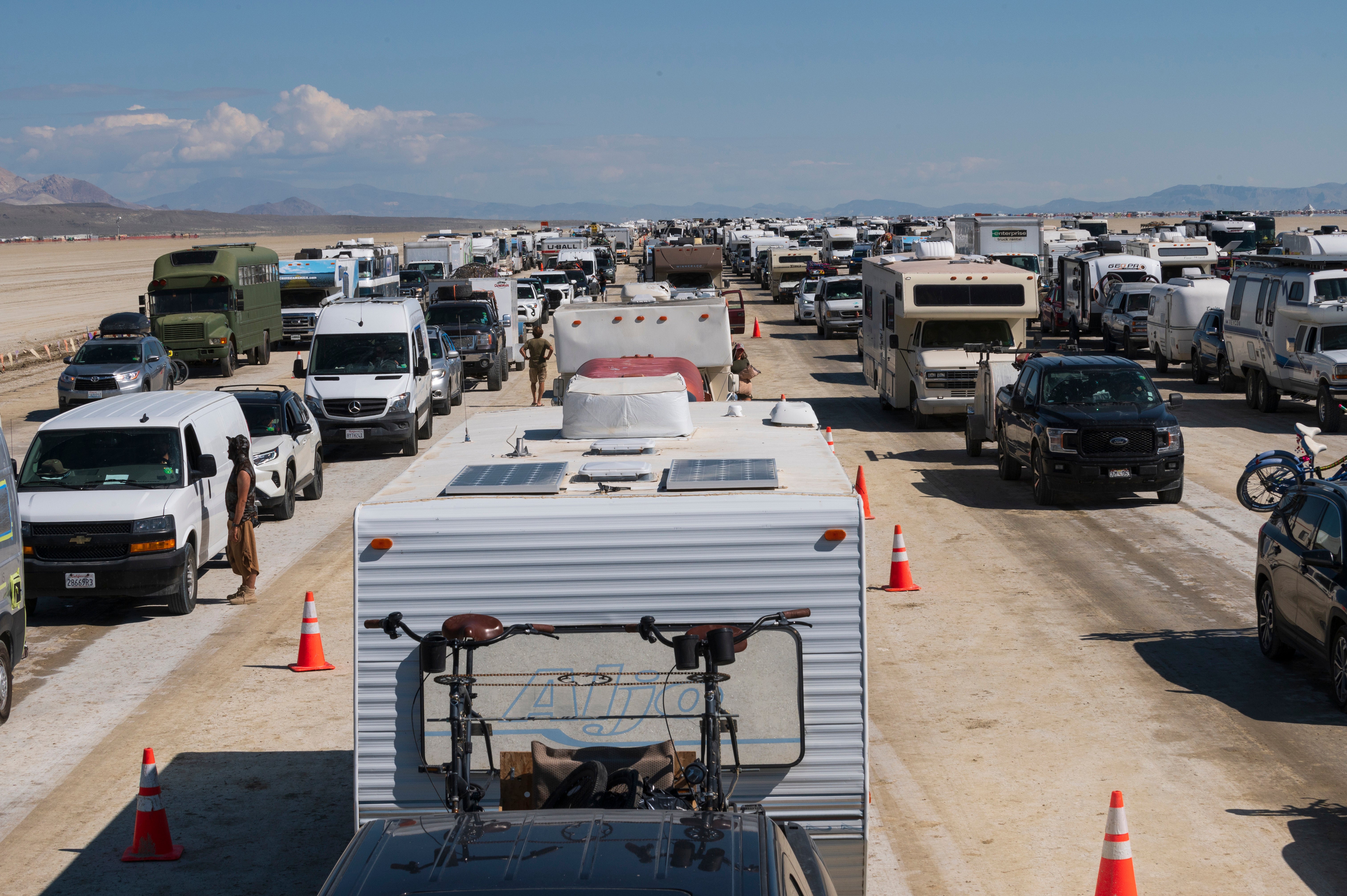 Vehicles line up to leave the Burning Man festival in Black Rock Desert, Nev., Tuesday, Sept. 5, 2023