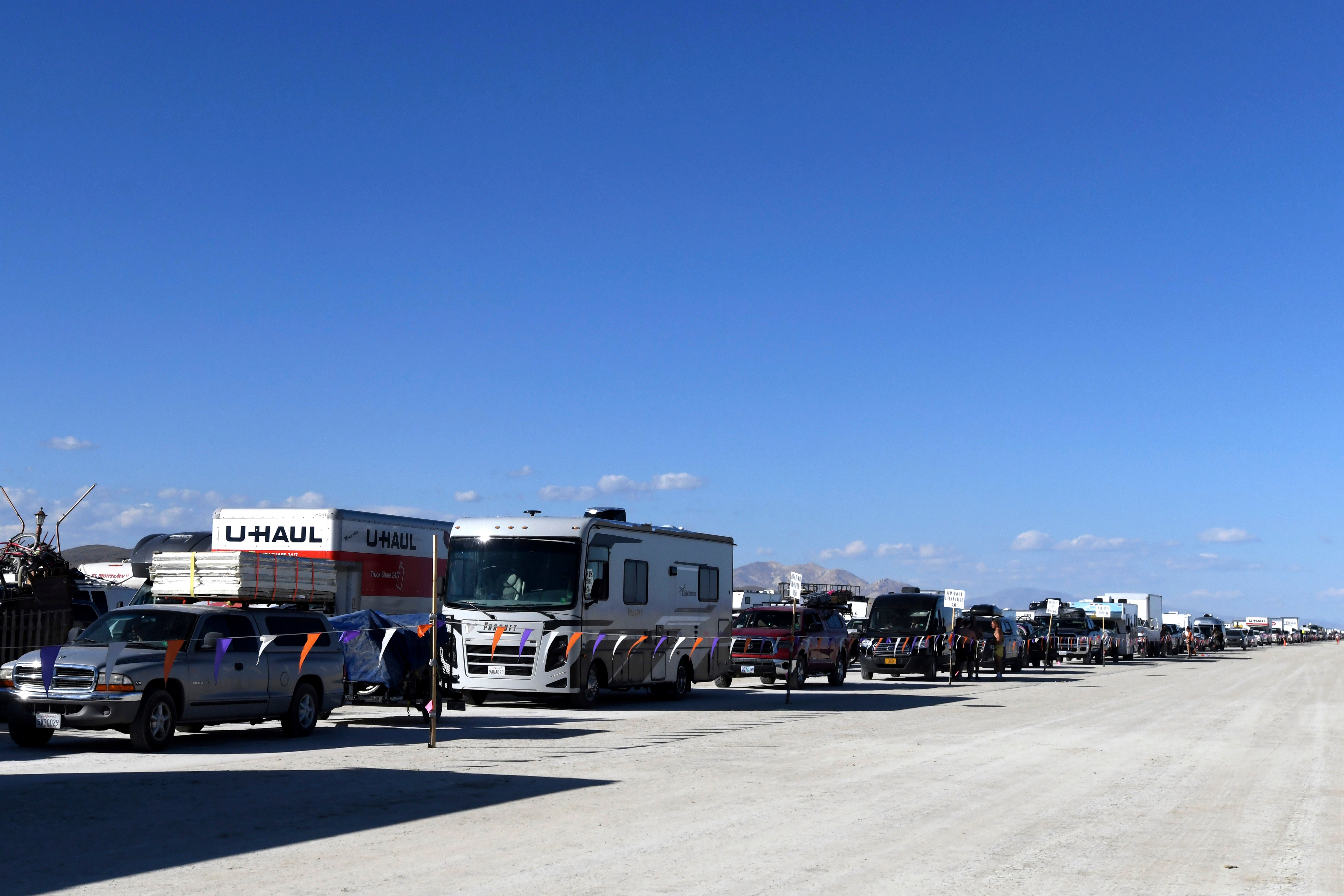 Vehicles line up to leave the Burning Man festival in Black Rock Desert, Nev., Tuesday, Sept. 5, 2023.