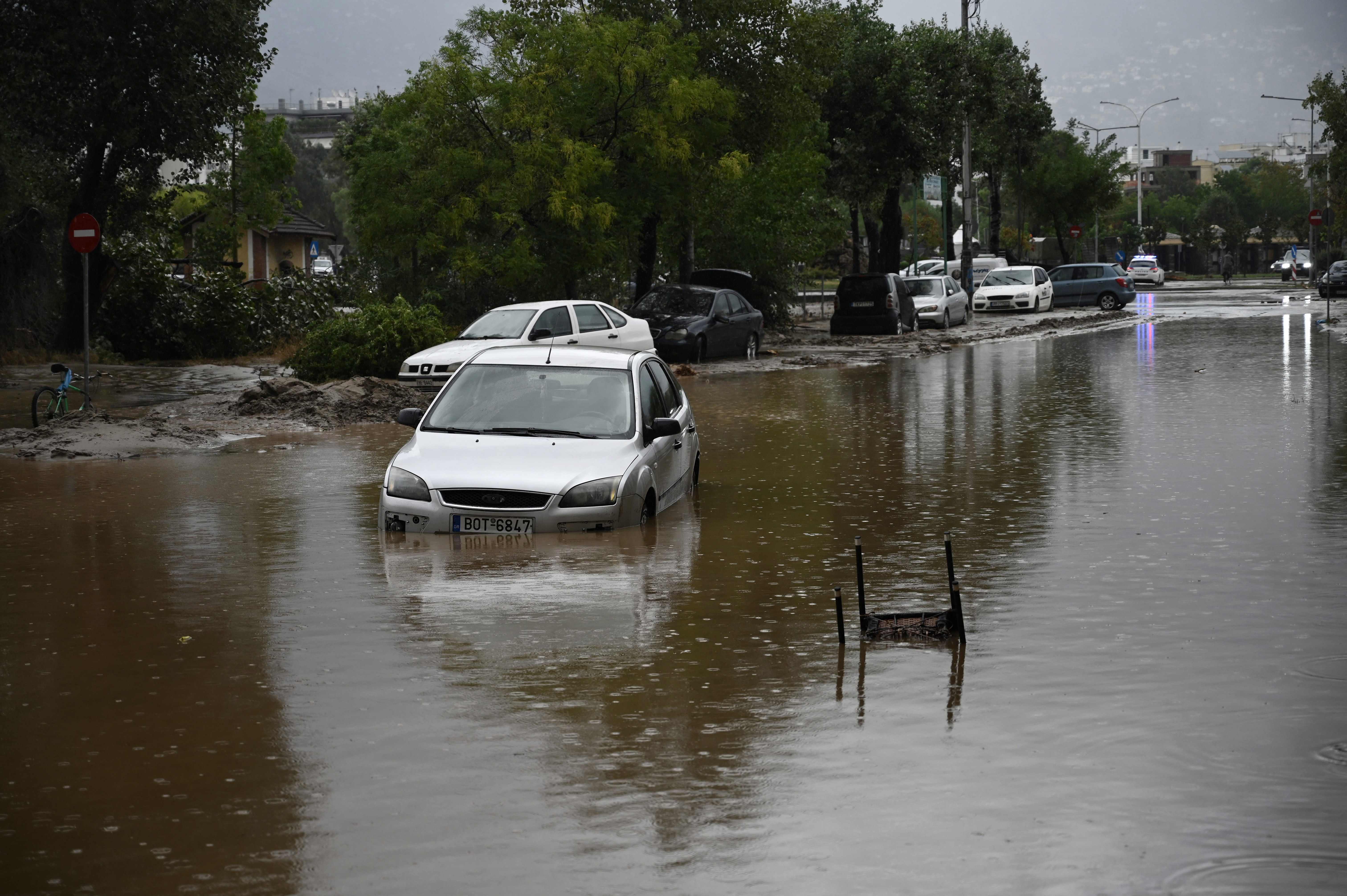 A photo shows cars in a flooded road in the city of Volos, central Greece