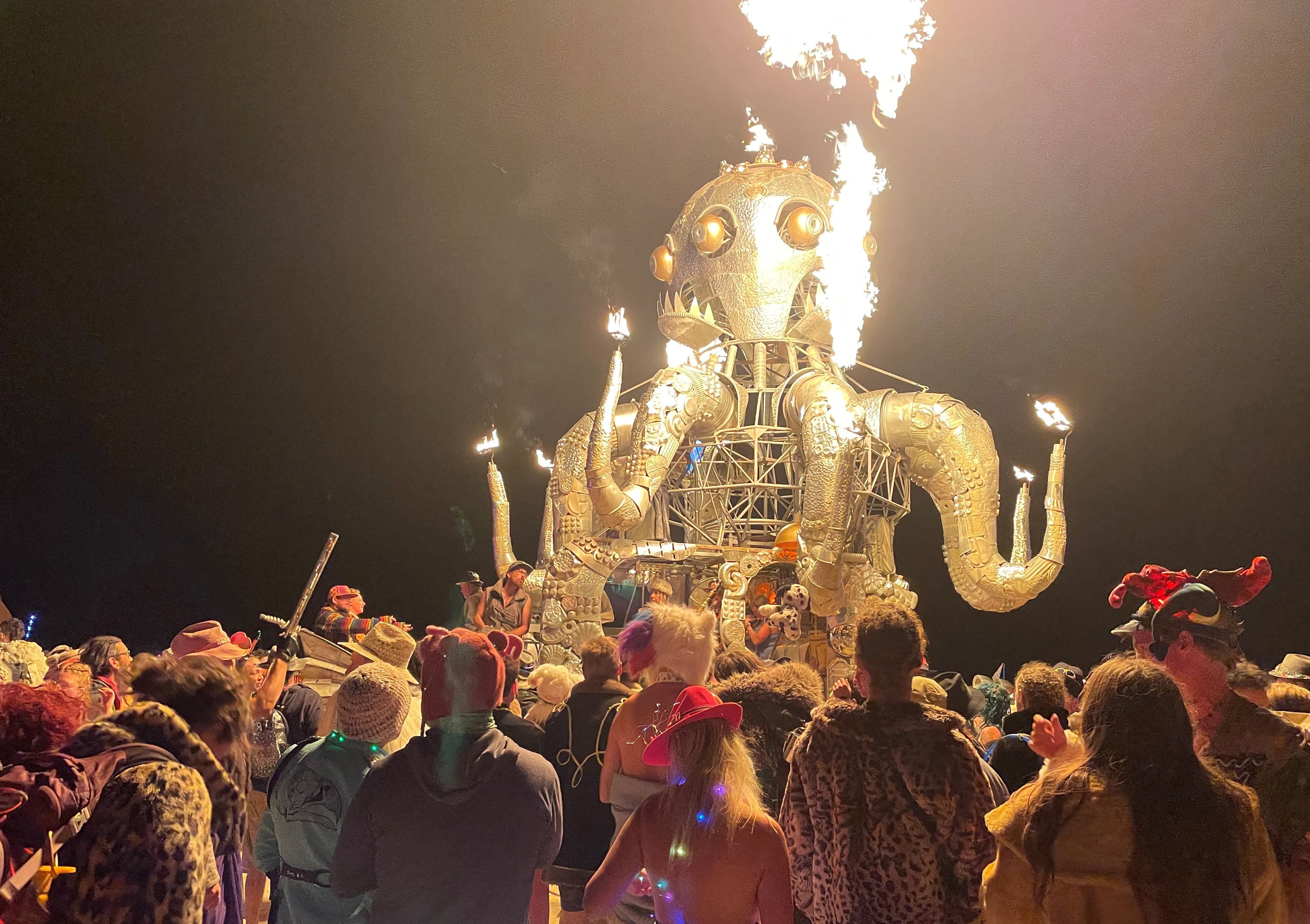 Attendees dance during the annual Burning Man Festival in the early morning of September 5, 2023