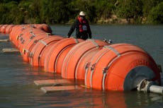 A judge orders Texas to move a floating barrier used to deter migrants to the bank of the Rio Grande