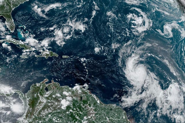 <p>This Wednesday, Sept. 6, 2023, satellite image provided by the National Oceanic and Atmospheric Administration shows Hurricane Lee, right, off in the central tropical Atlantic Ocean</p>