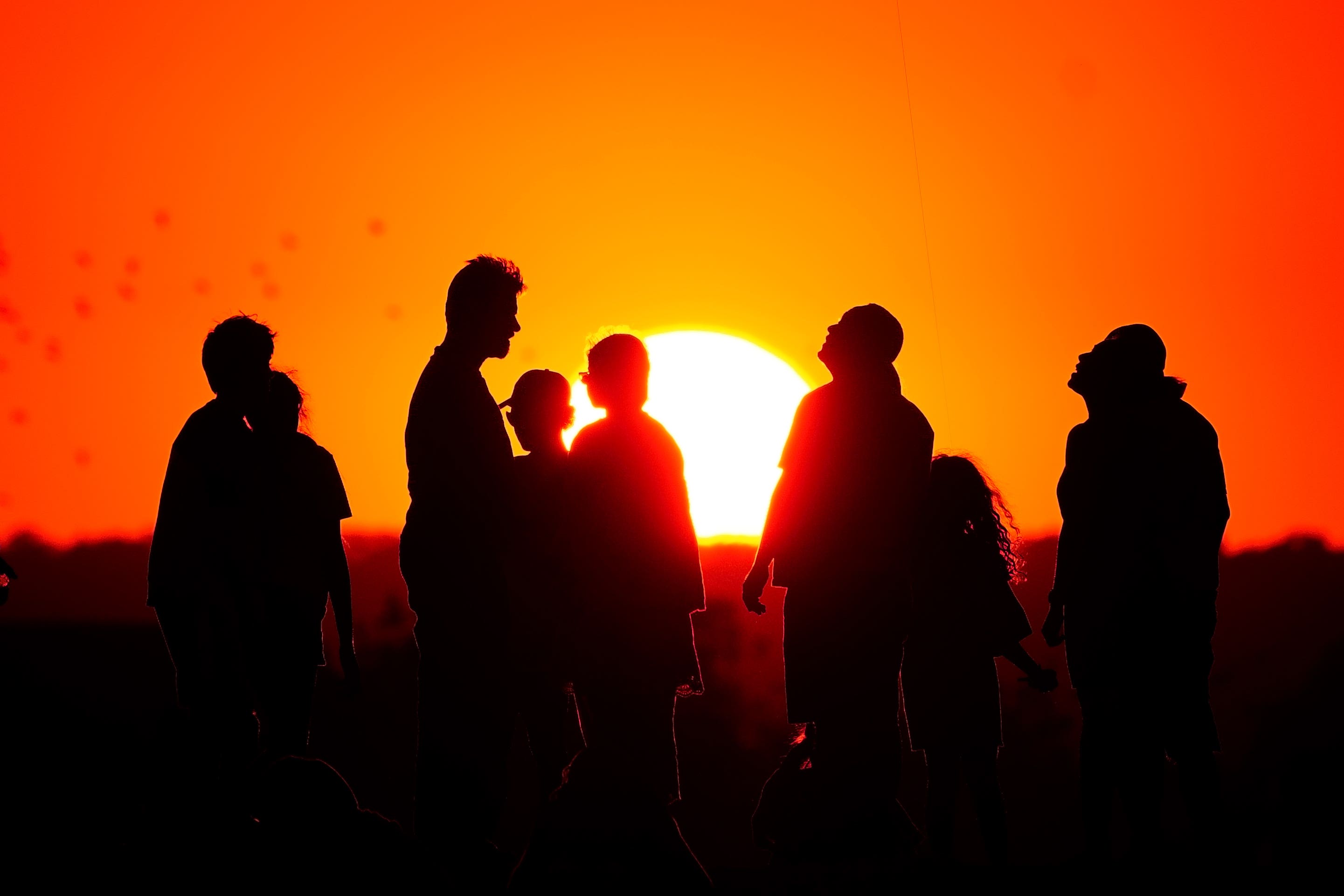 A crowd of people watch the setting sun from a hill in Ealing, west London. (Victoria Jones/PA)