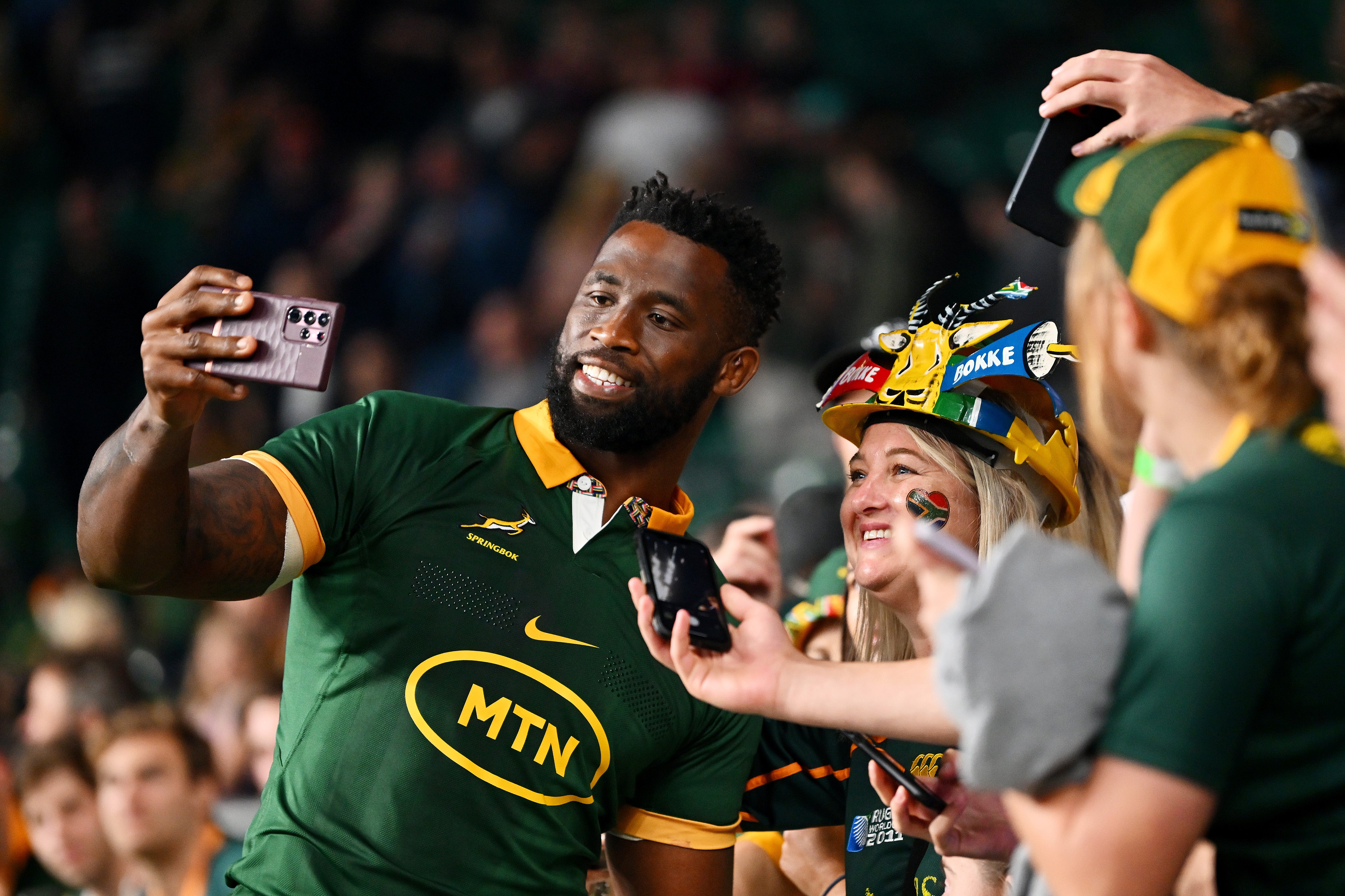 Siya Kolisi poses with a fan after beating New Zealand at Twickenham