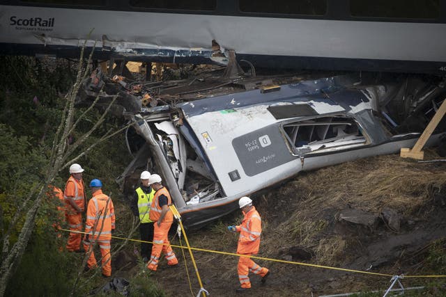 A woman has told how she was hurled out of a window of the train in the Stonehaven derailment (PA)