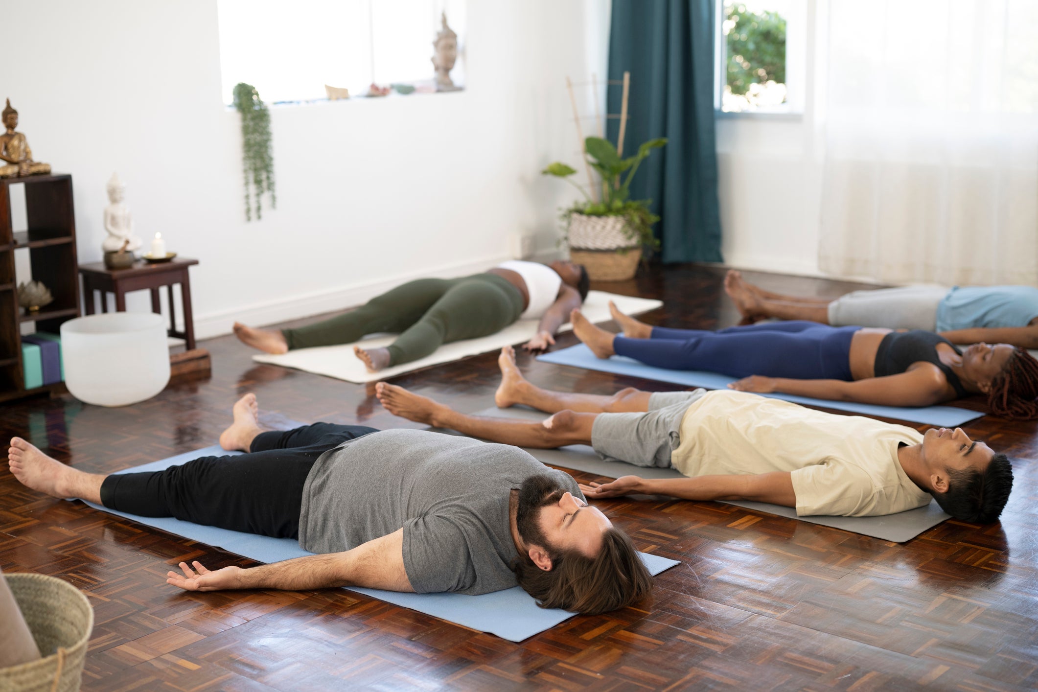 (File image) People lying down in Shavasana at end of yoga class
