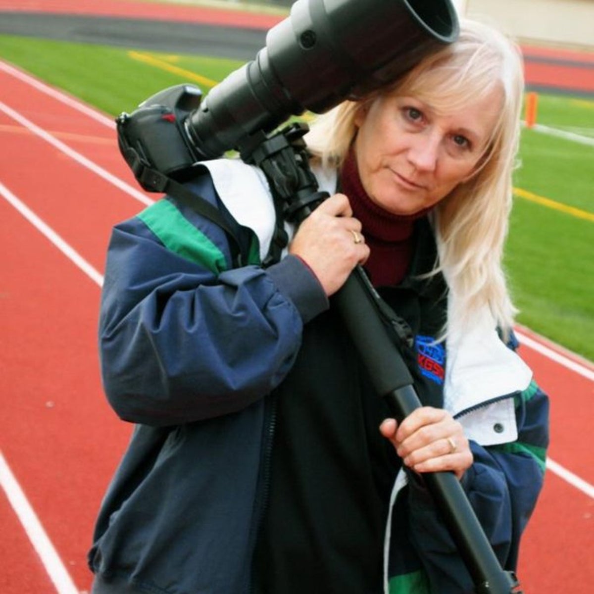 Photographer dies after high school football players crash into her during game