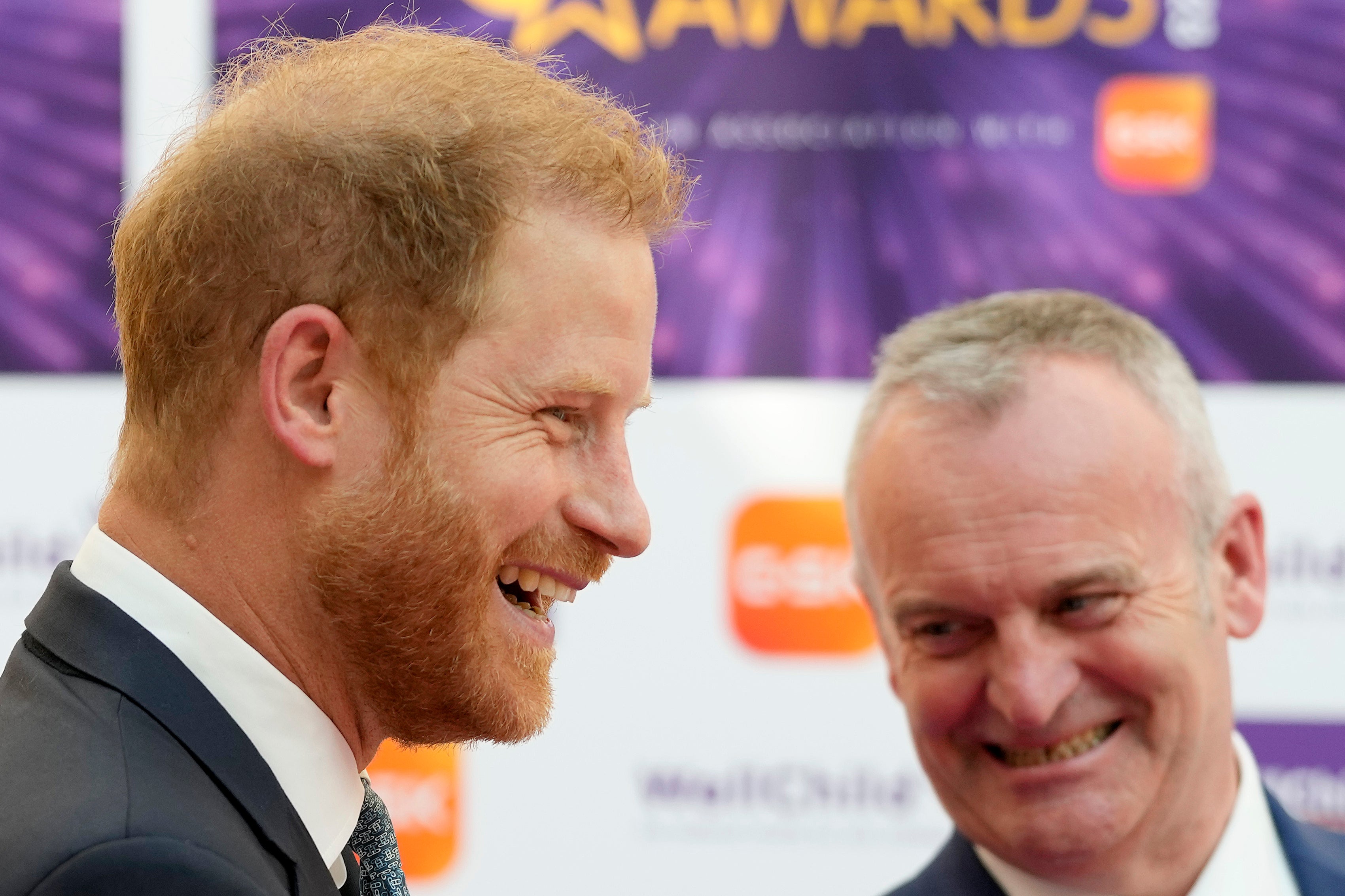 Prince Harry shares a joke with Craig Hatch, Chairman of WellChild